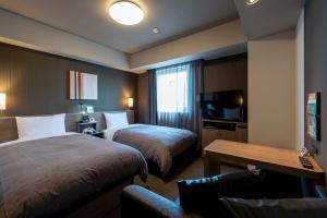 Postel nebo postele na pokoji v ubytování Hotel Route-Inn Kanuma Inter