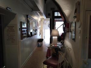 a hallway with a table and chairs in a room at Chalet Saint Louis in Lourdes