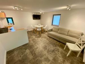 a living room with a couch and a table at Quartier am Haff in Ueckermünde