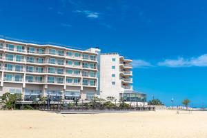 a large hotel on the beach next to the beach at Kensington Resort Seorak Beach in Sokcho