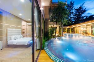 a house with a bedroom and a swimming pool at Tree Scape Retreat Resort in Chiang Mai