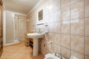 a bathroom with a sink and a toilet at Villa Chia in Domus de Maria +27 photos
