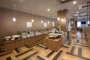 a lobby of a restaurant with wooden walls at Hotel Route-Inn Yamagata South - in front of University Hospital - in Yamagata