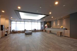 a large lobby with a waiting room with a skylight at Hotel Route-Inn Yamagata South - in front of University Hospital - in Yamagata