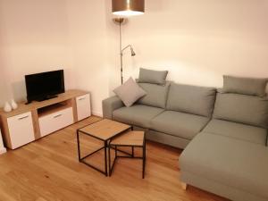 a living room with a couch and a tv at Casa Kühnle in Friedrichshafen