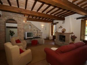a living room with two chairs and a fireplace at Belvilla by OYO Villa Monte Acuto in Galera