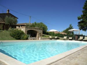 a swimming pool in front of a house at Belvilla by OYO Villa Monte Acuto in Galera