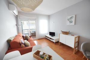 a living room with a couch and a table at Desconnectar Tossa de Mar in Tossa de Mar +5 photos