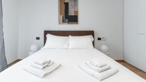a bedroom with a white bed with towels on it at Italianway - Lazzaro Papi 14 A in Milan