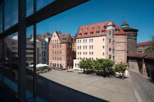 a view of a city from a window of a building at Hotel VICTORIA Nürnberg in Nuremberg