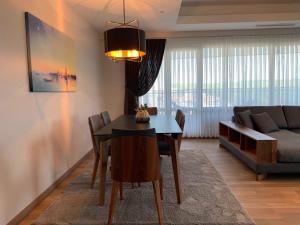 a living room with a dining room table and a couch at Maslak Aparts in Istanbul
