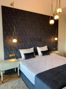 a bedroom with two beds and a large headboard at Maslak Aparts in Istanbul