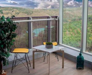 a balcony with a table and two chairs and a window at Maslak Aparts in Istanbul