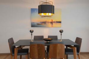 a dining room with a black table and chairs at Maslak Aparts in Istanbul