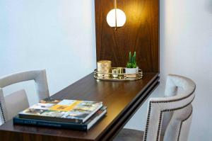 a dining room table with two chairs and a book at Maslak Aparts in Istanbul