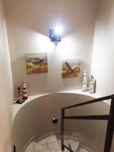 a bathroom with two paintings on the wall and a glass floor at Villa Siesta Flat No.2 in Margate