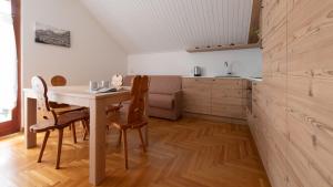 a kitchen and dining room with a table and chairs at Italianway - Besta 2 in Bormio