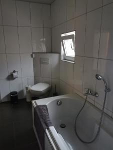 ein Badezimmer mit Badewanne und Toilette in der Unterkunft Ferienhaus Thalia in Übach-Palenberg + 5 Fotos