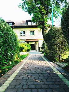 a cobblestone driveway in front of a house at Hotel Vistula in Krakow