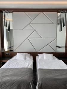 dwa łóżka siedzące obok siebie w sypialni w obiekcie Hotel Falko w mieście Rumia