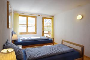 a room with two beds and a window at Haus Liaun 2 in Brienz-Brinzauls