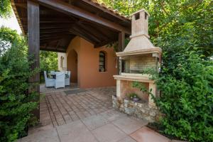 a patio with a stone fireplace in a house at Iason Villas – Chania, Crete in Maleme