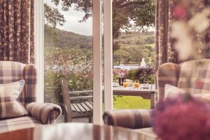 an open door to a patio with a table and chairs at Lakeside Hotel and Spa in Newby Bridge
