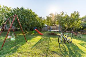 un patio con dos columpios y dos bicicletas en el césped en Holiday Home Kerniat, en Šišan