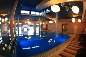 a large indoor pool in a building with a swimming pool at Apartment Vita near Terme Paradiso in Dobova