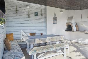 a patio with a table and a bench at Royal Villas in Bryastovets