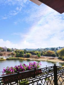 a view of a pond with flowers on a fence at Melania in Umanʼ