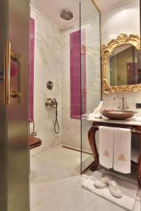 a bathroom with a bath tub, toilet, sink and mirror at Daru Sultan Hotels Galata in Istanbul