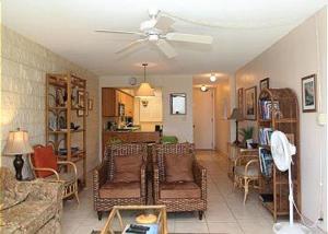 a living room with a couch and a ceiling fan at Kanai A Nalu Resort 205 in Wailuku