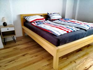 a bed with red white and blue blankets and pillows at Casa Kühnle in Friedrichshafen