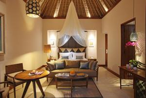 a living room filled with furniture and a fireplace at Tejaprana Resort & Spa - CHSE Certified in Ubud