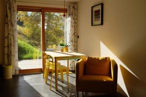 a dining room with a table and a chair and a window at Iglusaq Lodge in Veysonnaz