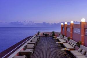 a row of wooden benches sitting on top of a pier at Terceira Mar Hotel in Angra do Heroísmo