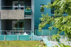 a blue building with a ramp in front of it at Hotel Savoy in Grado