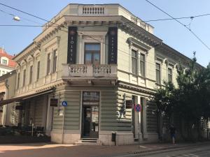 an old wooden building on the corner of a street at Soleil Apartman Szeged in Szeged