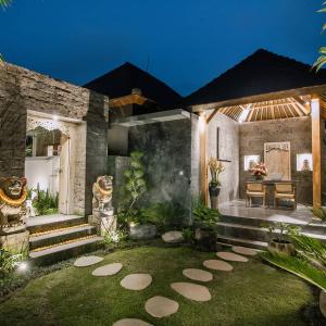 a house with a garden at night with lights at Ubud Season Villas in Ubud