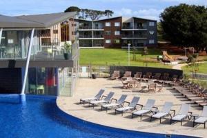 a swimming pool with lounge chairs and a swimming pool at Stunning resort apartment in San Remo in San Remo