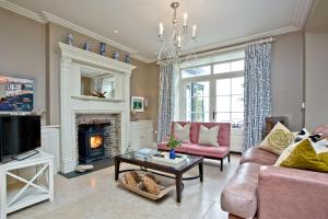a living room with a couch and a fireplace at Golden Meadow, Torcross in Stokenham