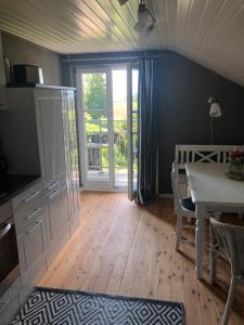 a dining room with a table and a door to a patio at Bella Vista in Laufen