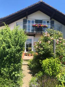 a house with a balcony with flowers on it at Bella Vista in Laufen