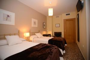 Ένα ή περισσότερα κρεβάτια σε δωμάτιο στο Apartamentos Turísticos Ceres