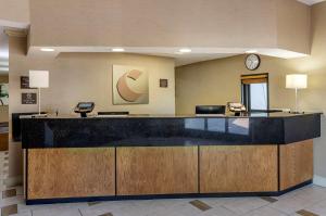 a lobby with a reception desk with a clock at Comfort Inn Roanoke Civic Center in Roanoke