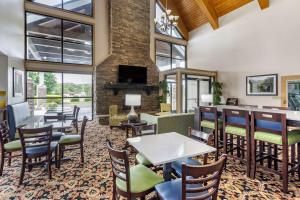 Quality Inn في Ocoee: مطعم بطاولات وكراسي ومدفأة