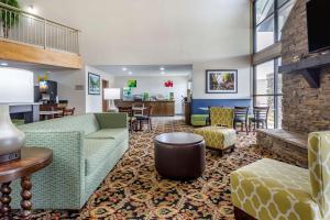 a hotel lobby with a couch and chairs and tables at Quality Inn in Ocoee