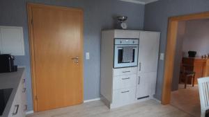 a kitchen with a refrigerator and a microwave at Fewo Greifenstein in Greifenstein