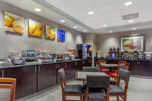 a restaurant with a counter with tables and chairs at Comfort Inn Kearney I-80 in Kearney